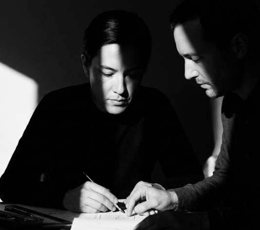 Two Syzygy colleagues carefully reviewing a document together